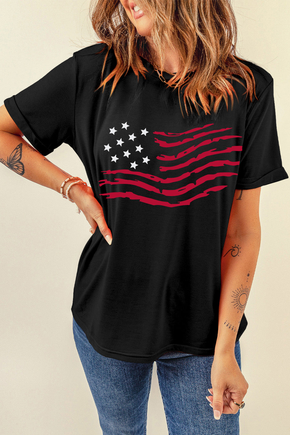 Black t-shirt with distressed American flag graphic and rolled sleeves.