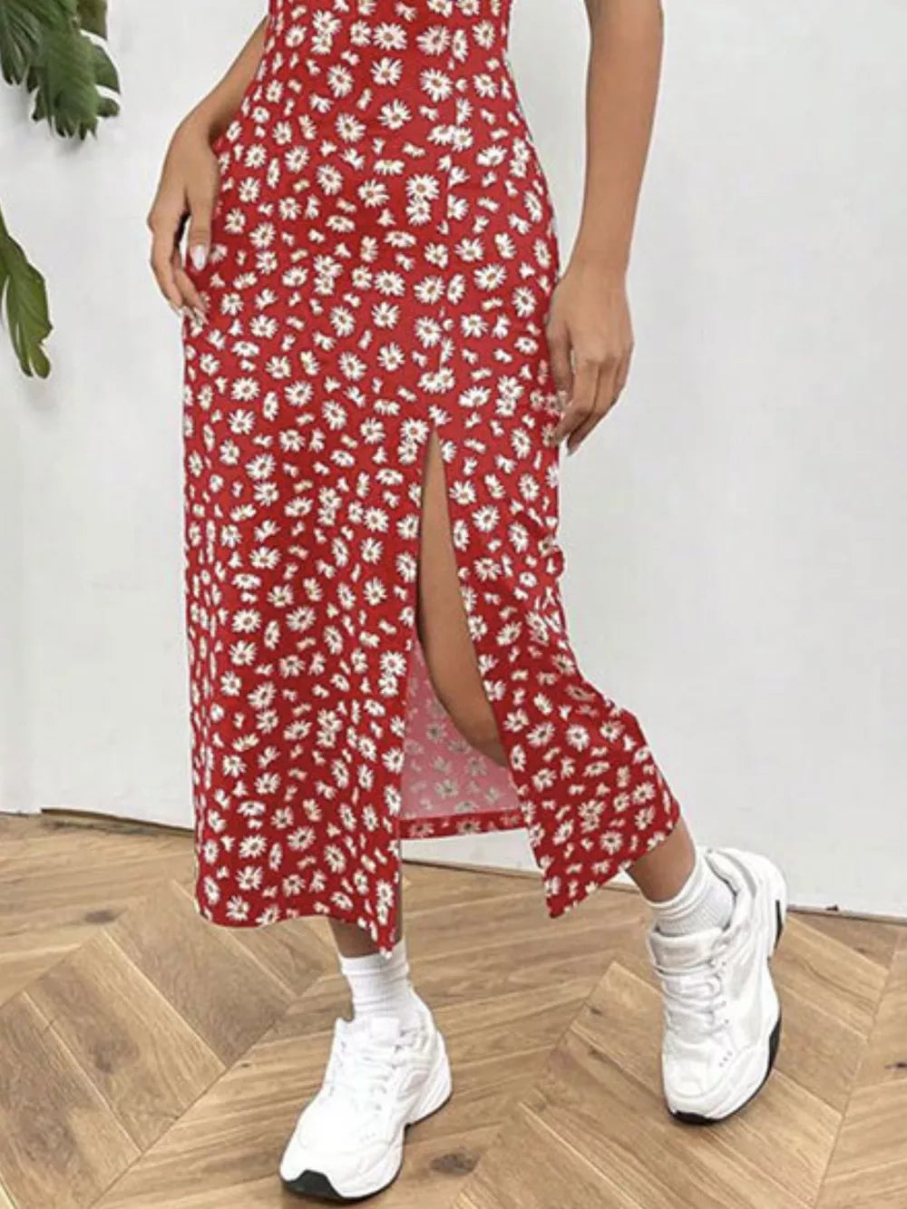 Red floral spaghetti strap midi dress with a thigh-high slit.