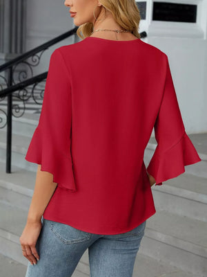 Red V-neck blouse with ruffle sleeves, a basic style for women.