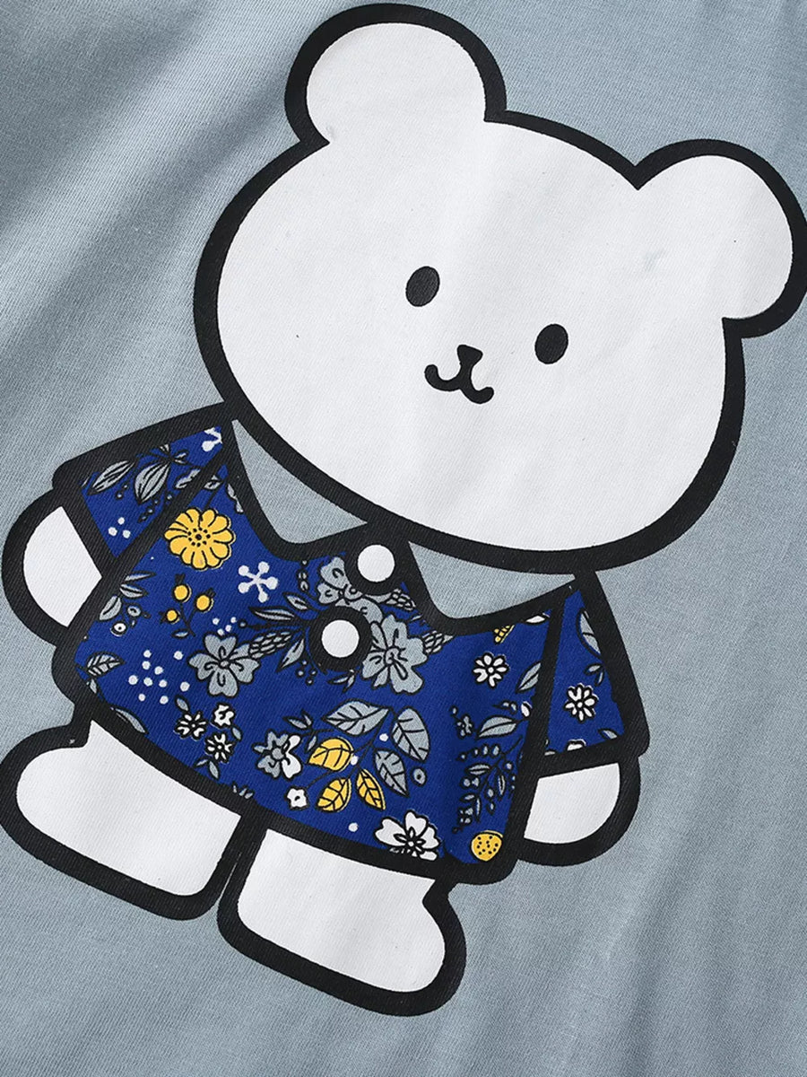 Baby t-shirt with playful bear graphic and blue floral print shirt detail.