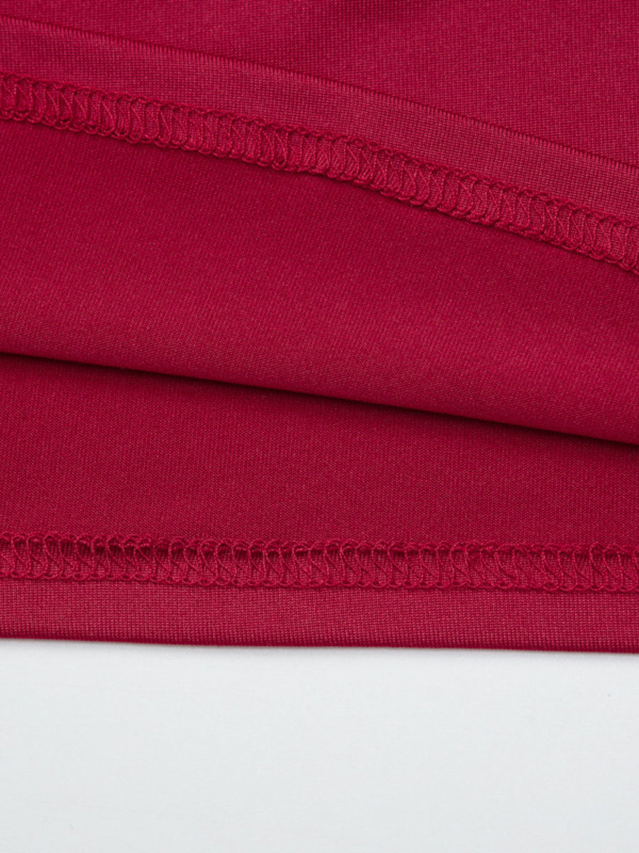 Red fitted one-shoulder t-shirt detail showing fabric texture and stitching.