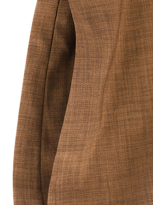 Brown wide leg jumpsuit with textured fabric and a side pocket detail.
