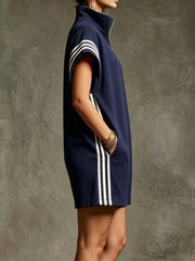 Navy blue sporty zip-up romper with white stripes on sleeves and sides, and pockets.