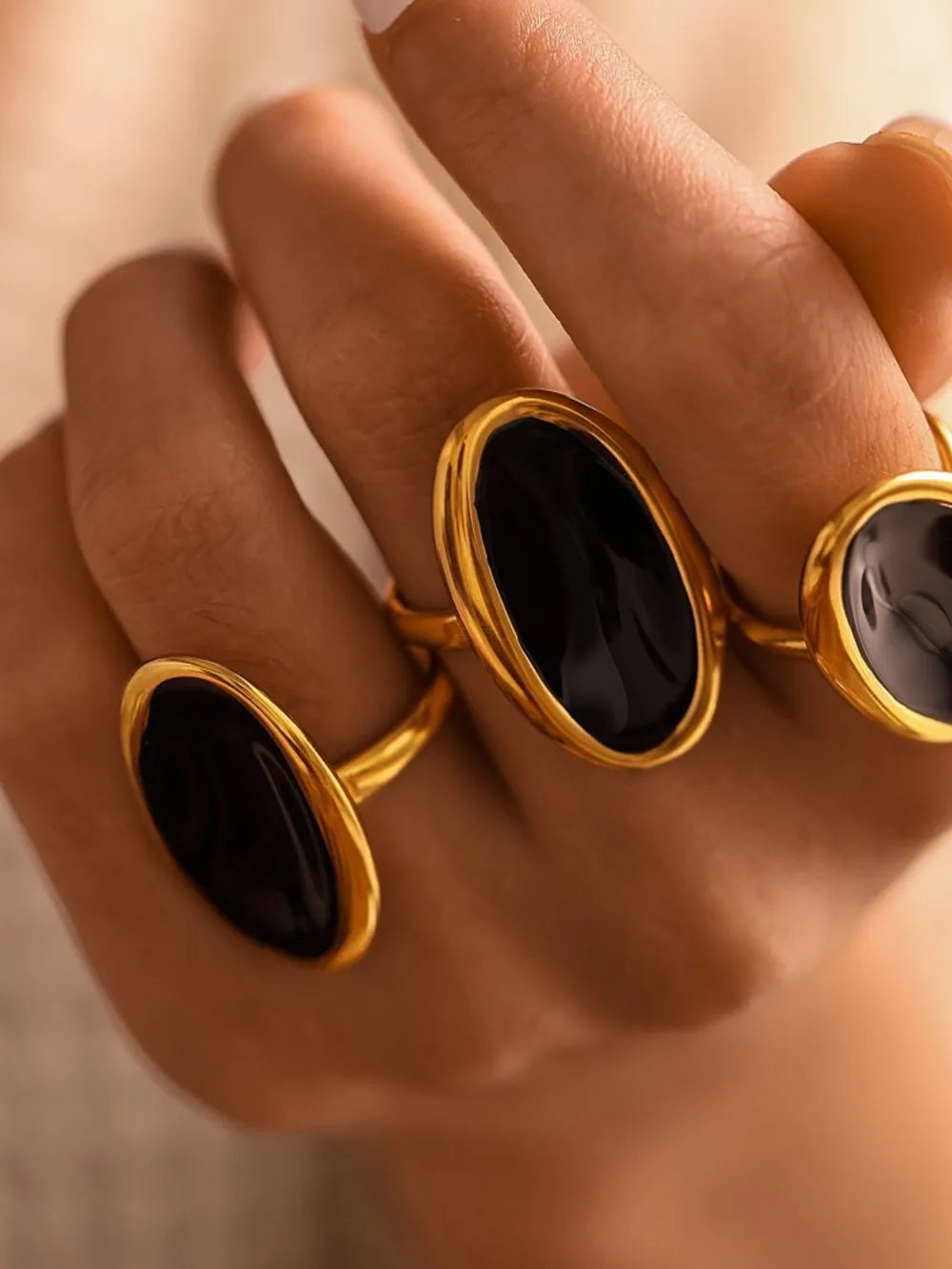 Gold oval onyx cocktail ring with a polished finish.