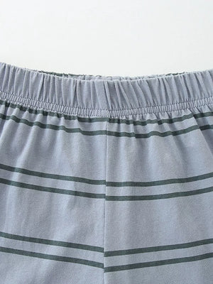 Light blue cotton toddler sleep pants with dark green horizontal stripes and elastic waistband.