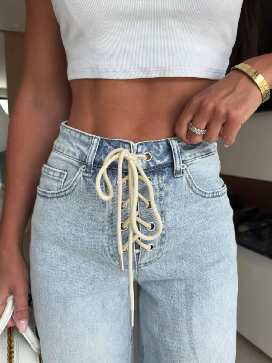 Light wash denim wide leg jeans with a lace-up front detail and high waist.