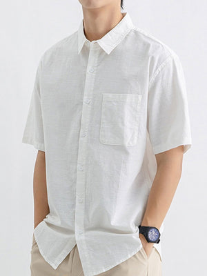 Men's white short sleeve button-up shirt with chest pocket and spread collar
