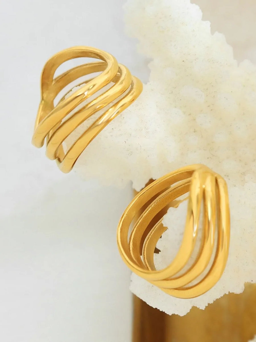 Gold triple-band sculptural ring with smooth, polished finish.