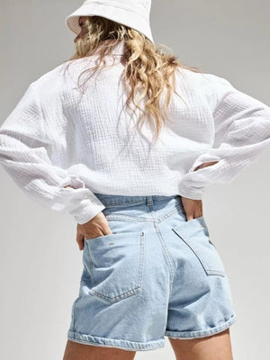 Blue button-down shirt with tunic-length and button-front