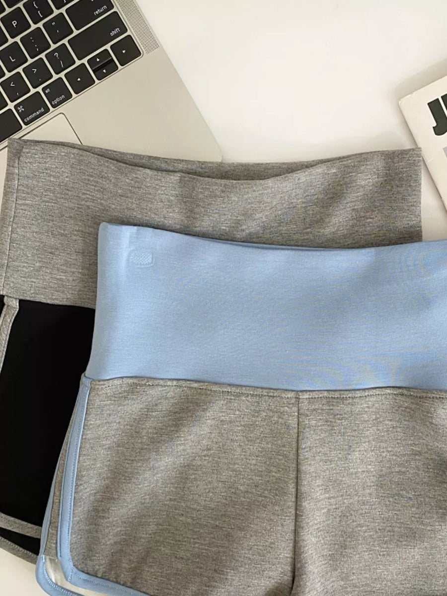 Light blue and gray athletic jogger shorts with contrast trim and high-rise waist.