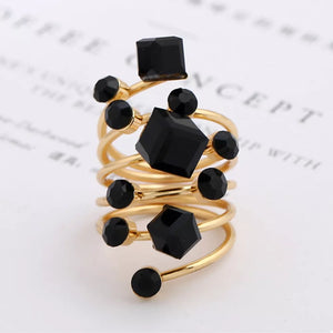 Gold-plated ring with black crystals in geometric shapes, multi-layered spiral design