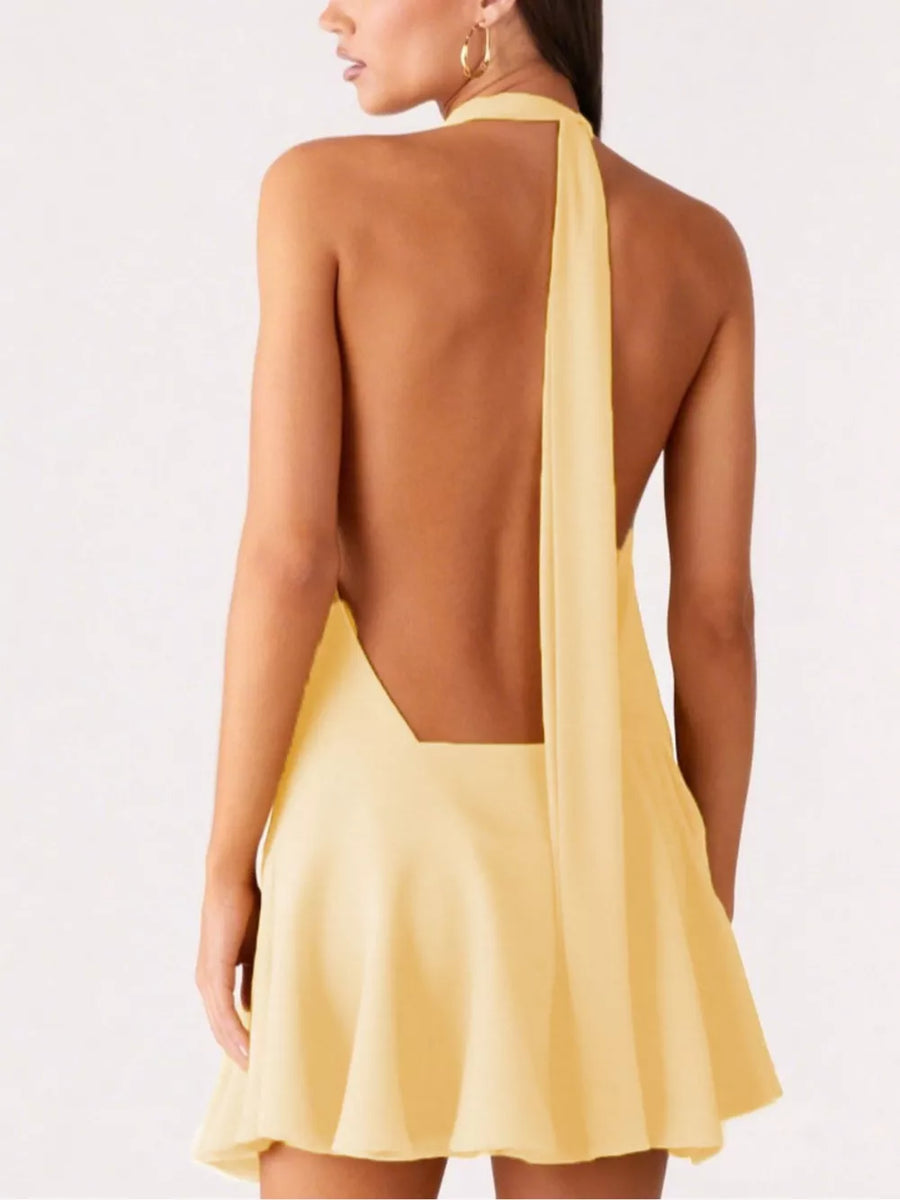 Yellow halter neck mini dress with open back and flowing tie detail