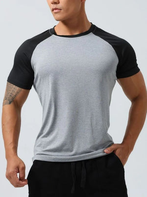 Raglan sleeve performance tee in light gray with black sleeves and neckline.