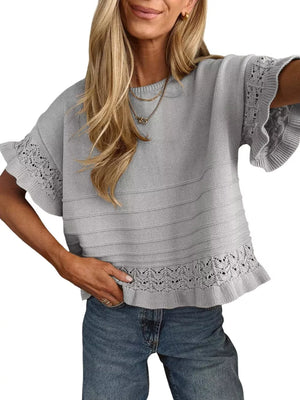 Grey knit top with crew neck, short sleeves, and delicate lace accents on cuffs and hem.
