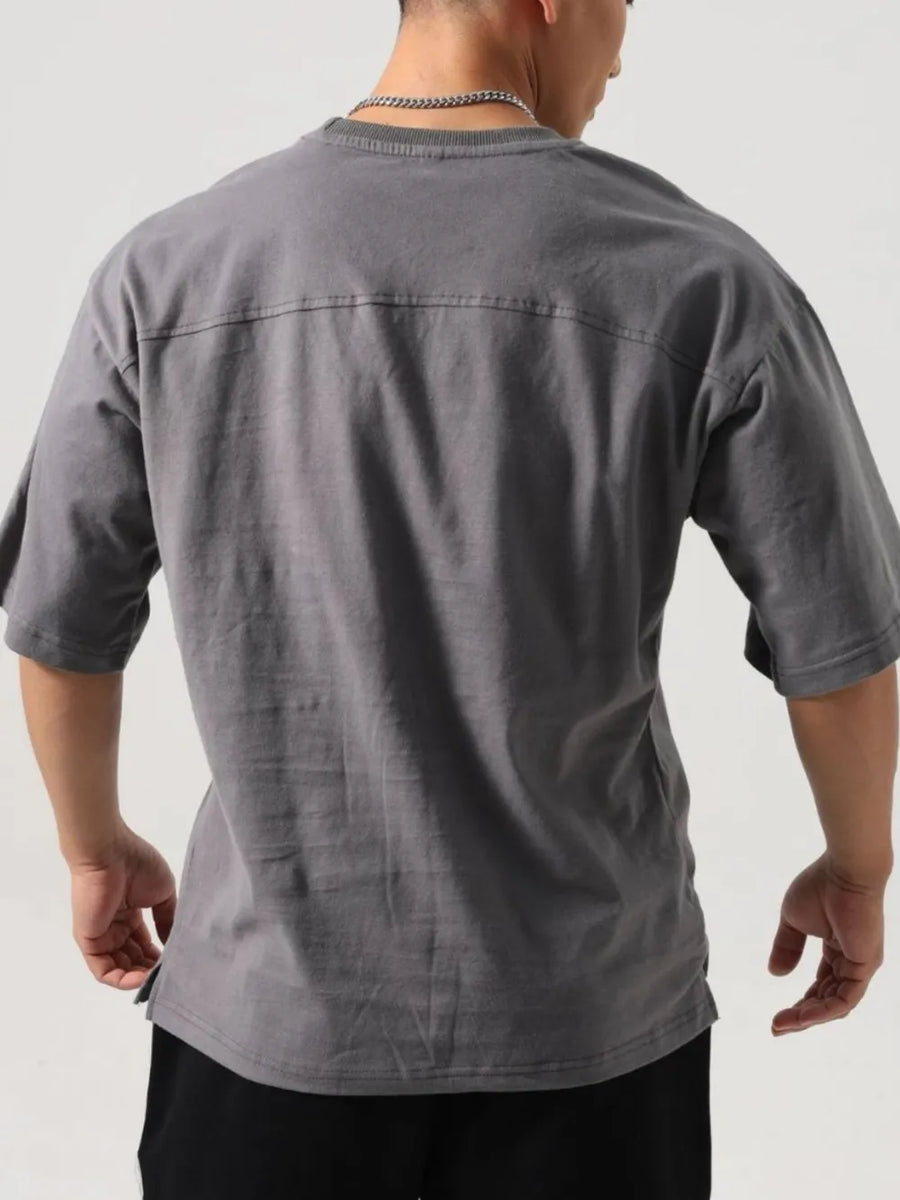 Gray washed cotton t-shirt with boxy cut and seam detail on back yoke.