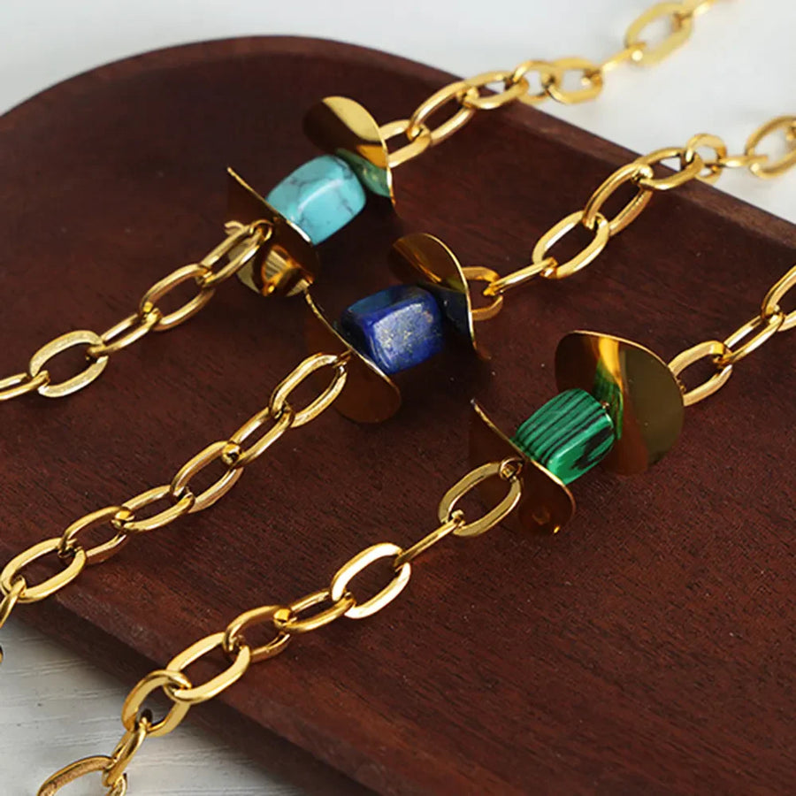 Geometric malachite pendant necklace with 18K gold-plated chain and blue, dark green stones.
