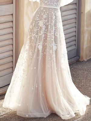 Lace flutter sleeve v-neck dress with floral embroidery and a flowing skirt.