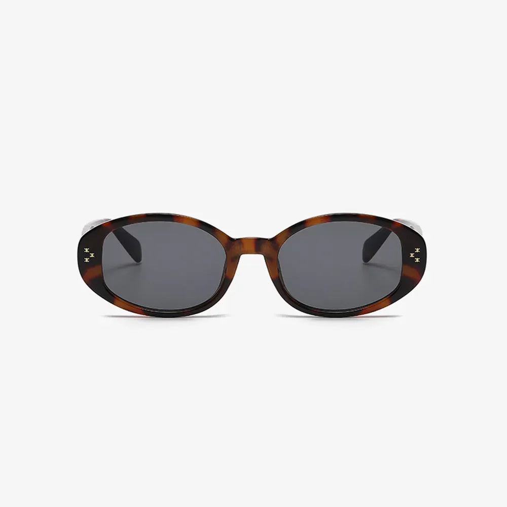 Tortoiseshell oval sunglasses with star embellishments and dark lenses