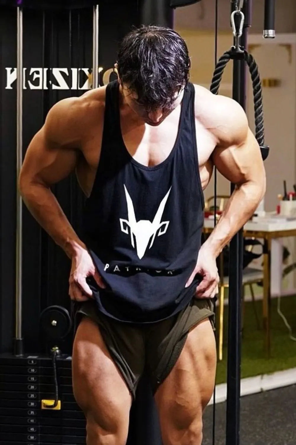 Black performance tank top with white graphic logo and text detail