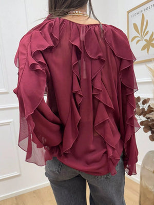 Burgundy sheer long-sleeve blouse with cascading ruffles.