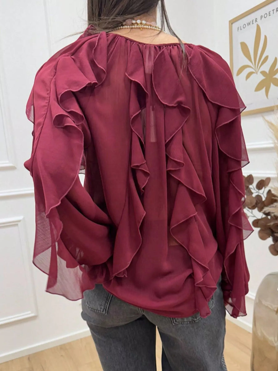 Burgundy sheer long-sleeve blouse with cascading ruffles.