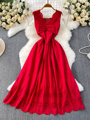 Red eyelet maxi dress with cutout detail and bow accent