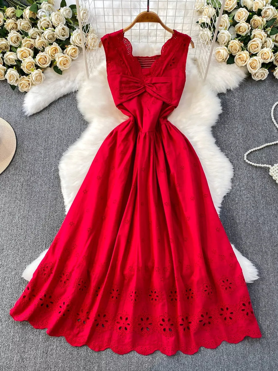 Red eyelet maxi dress with cutout detail and bow accent