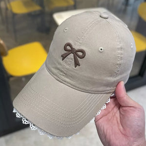 Khaki baseball cap with embroidered bow detail and lace trim