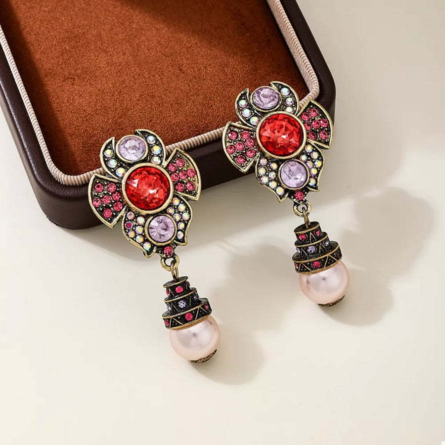 antique gold earrings featuring drop design and floral