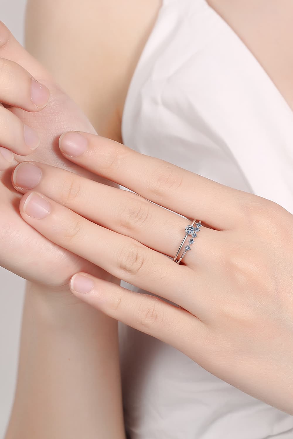 Silver layered ring set with moissanite sparkle details.