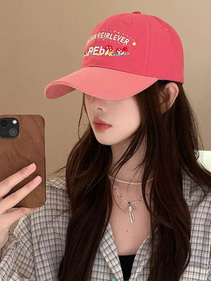 Hot pink baseball cap with embroidered mushrooms and text, featuring a contrasting blush pink brim.