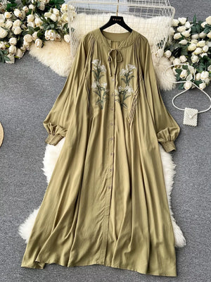 Khaki cotton maxi dress with embroidered floral detail and tie neck.