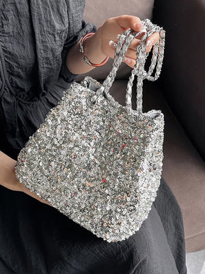 Dazzling sequin bucket bag in silver with a chain strap.