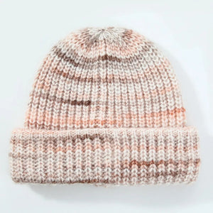 Textured mélange ribbed beanie in a multi-color blend of cream, pink, and brown acrylic.