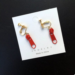 Red zipper dangle clip-on earrings with gold-tone hardware.