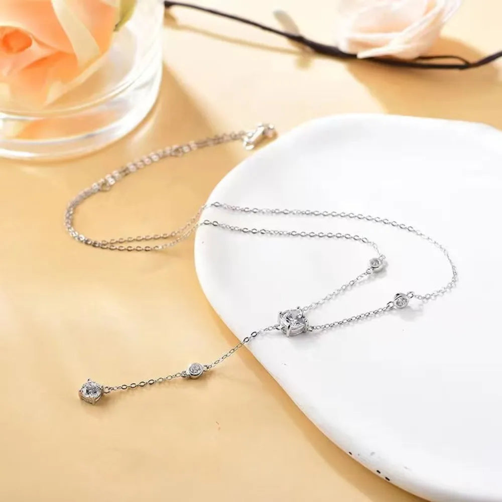 Silver lariat necklace with sparkling moissanite drop detail and scattered stones