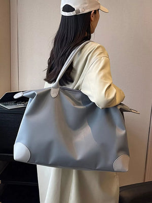 Grey Oxford cloth travel tote bag with light grey corner accents.