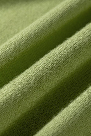 Green knit fabric with ribbed texture and soft fuzzy details.