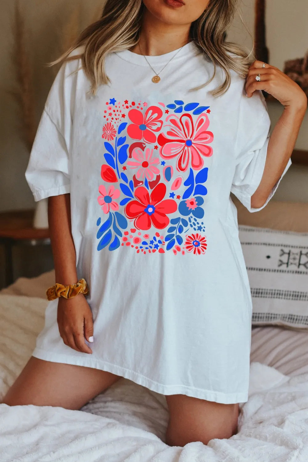 White oversized graphic tee dress with a vibrant floral print and short sleeves.