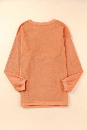 Sherbet corduroy crewneck sweatshirt with vertical ribbing and crew neckline.