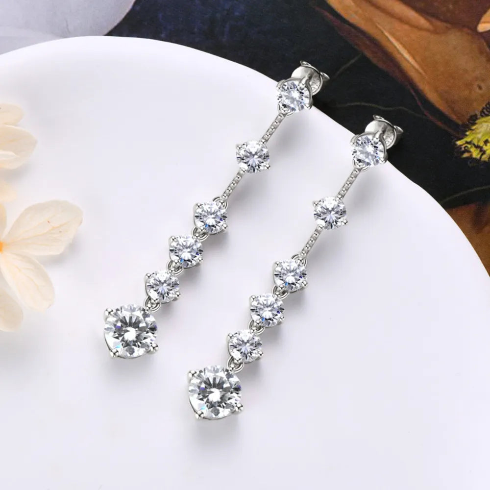 Silver cascading drop earrings with multiple clear cubic zirconia stones.
