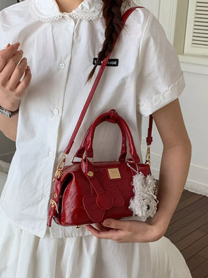 Charming Mini Bow-embellished Crossbody Bag in Burgundy with a fluffy charm.