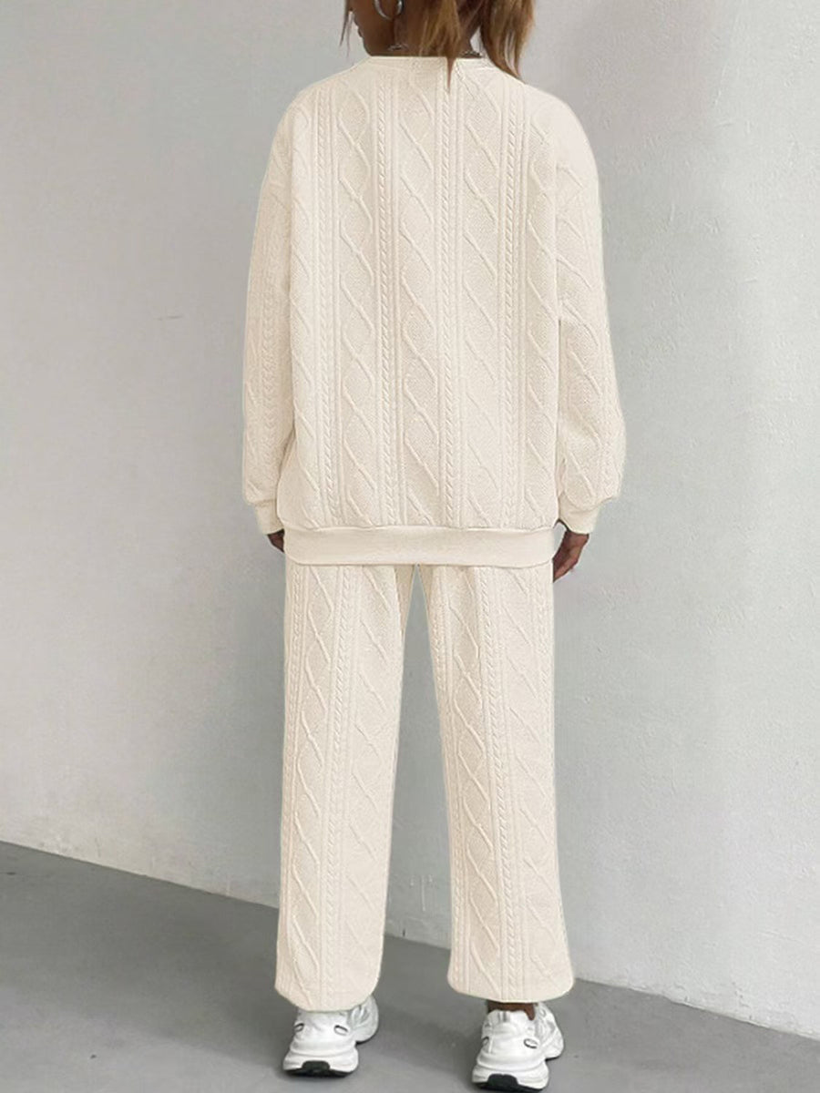 Beige cable knit lounge set with crewneck sweatshirt and wide-leg pants.