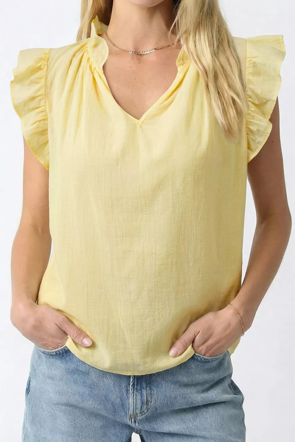 Yellow cotton blend V-neck shirt with ruffled cap sleeves and neckline