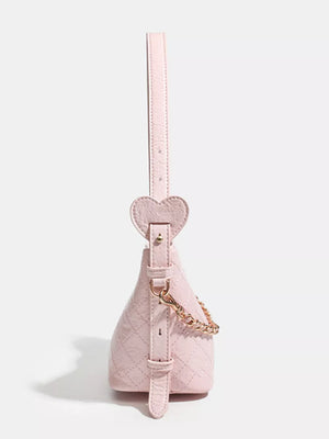 Pink quilted bucket bag with heart strap detail and gold chain accent