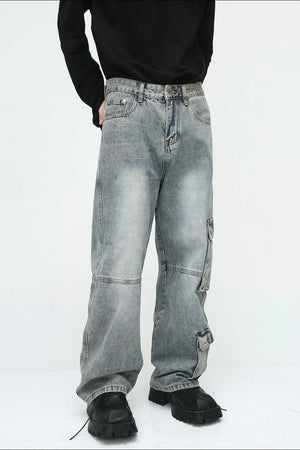 Medium wash wide leg cargo jeans with utility pockets and a relaxed fit.