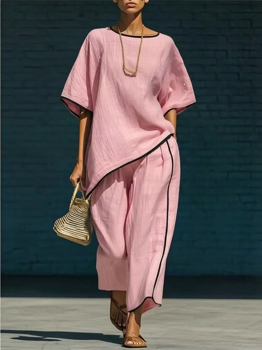 Pink two-piece set with contrast trim, half sleeves, and wide-leg pants.