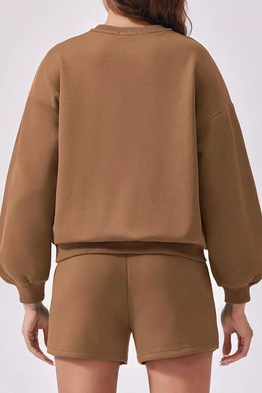 Caramel two-piece sweatshirt set with balloon sleeves and matching shorts.