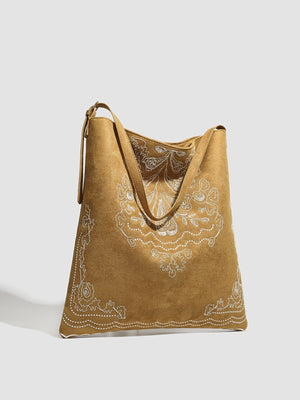 Brown handbag featuring embroidered and embroidered