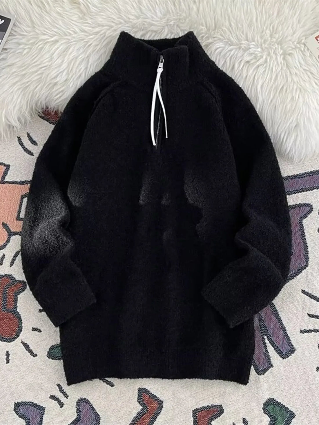 Men's black half-zip sweater with high neck and fuzzy texture.